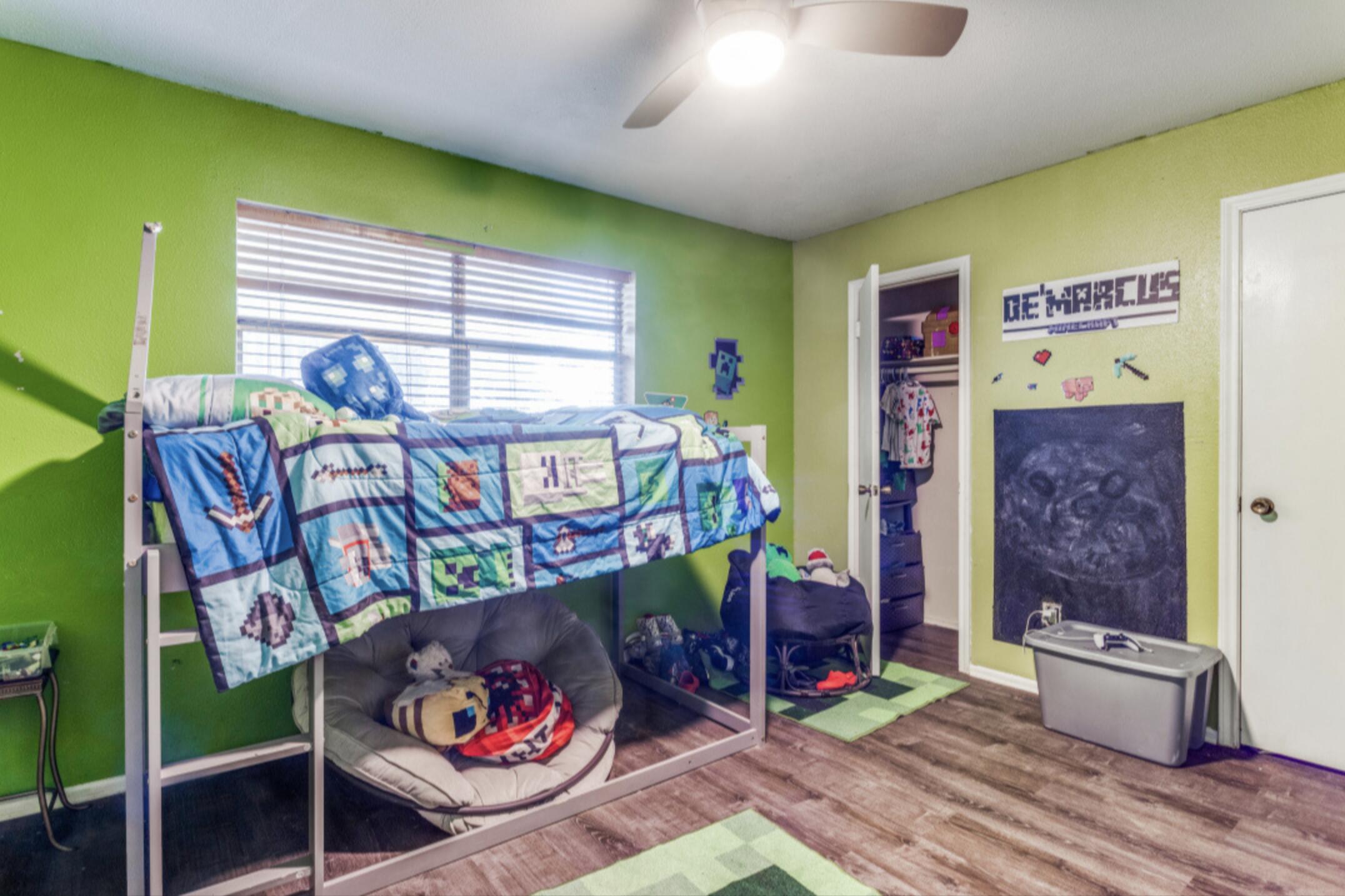 610 Pleasant Grove Road Elgin, TX 78621 - Photo 22 of 25 Bedroom featuring wood finished floors, ceiling fan, and a closet