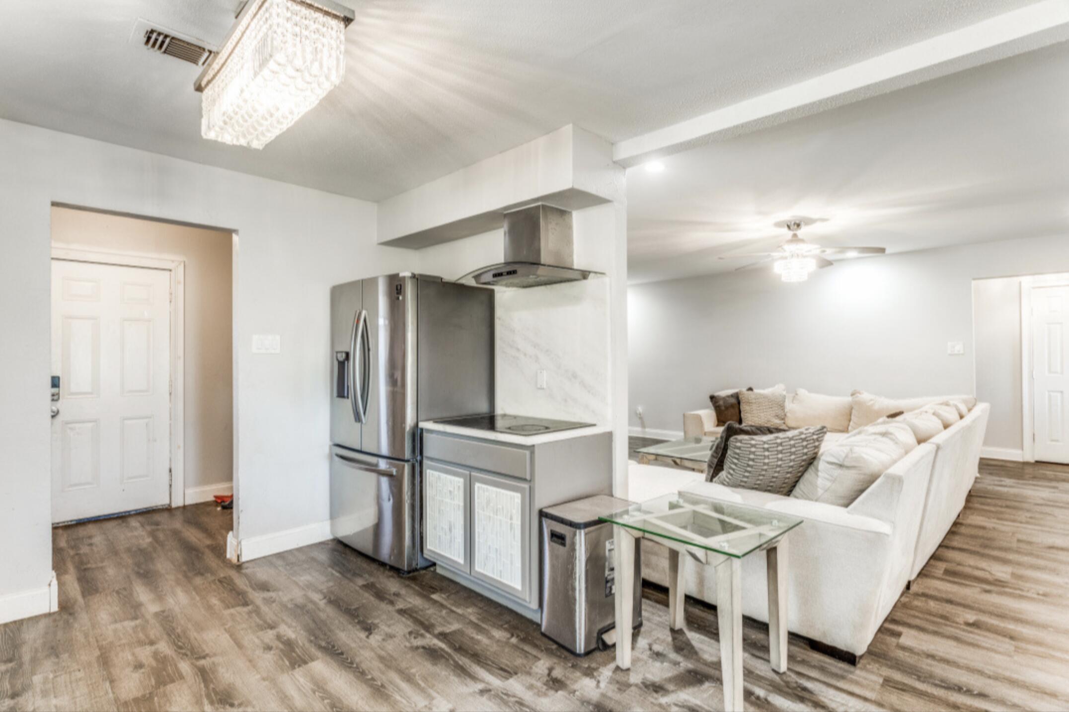 610 Pleasant Grove Road Elgin, TX 78621 - Photo 8 of 25 Kitchen featuring ceiling fan, light wood-style flooring, light countertops, stainless steel fridge with ice dispenser, and black electric cooktop