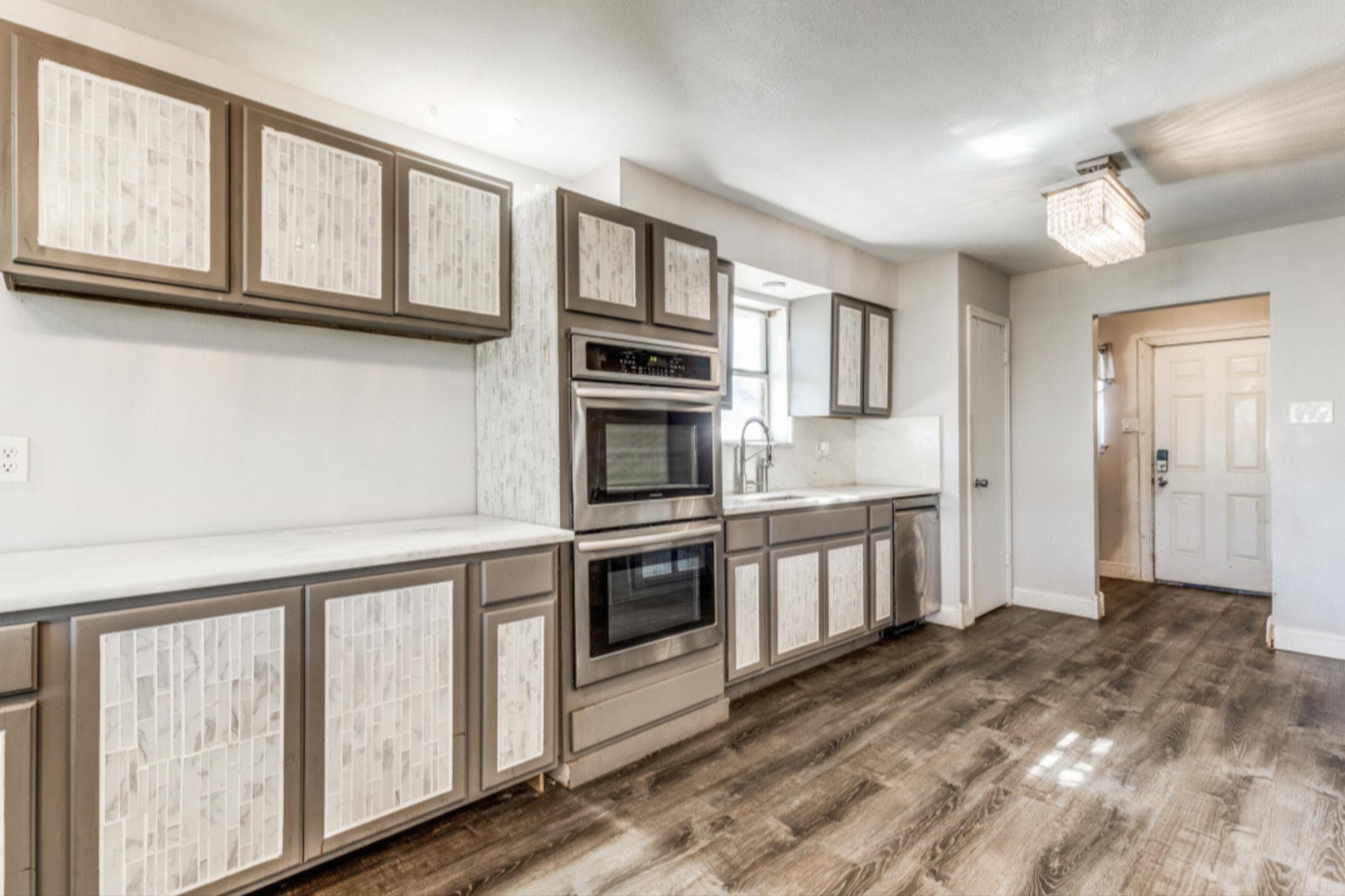 610 Pleasant Grove Road Elgin, TX 78621 - Photo 9 of 25 Kitchen with light countertops, stainless steel appliances, and dark wood-style floors