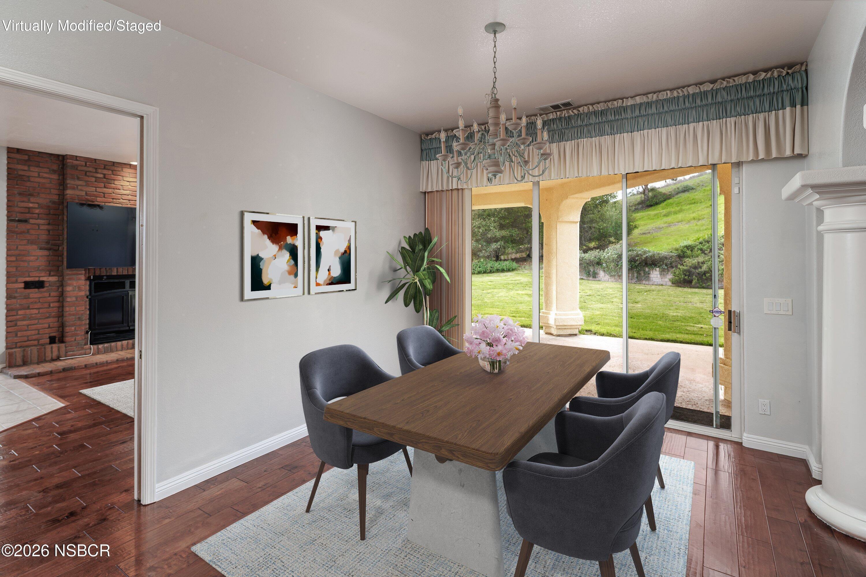 2655 Adobe Falls Road Lompoc, CA 93436 - Photo 14 of 51 a view of a dining room with furniture wooden floor and chandelier