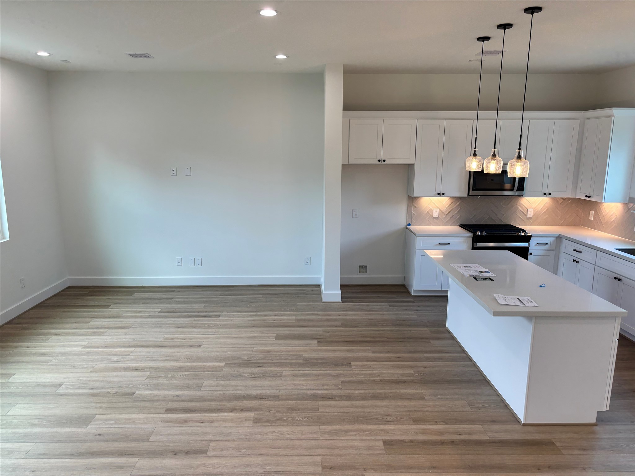 1034 Marcolin Street Houston, TX 77088 - Photo 15 of 25 a kitchen with stainless steel appliances granite countertop a sink a stove and a wooden floors