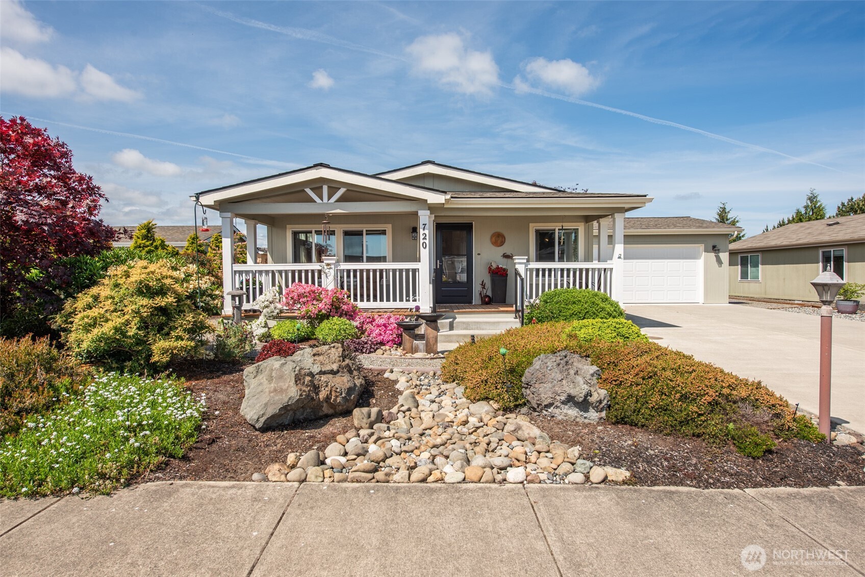 720 West Heritage Loop Sequim, WA 98382 - Photo 2 of 35 a front view of a house with a garden and plants