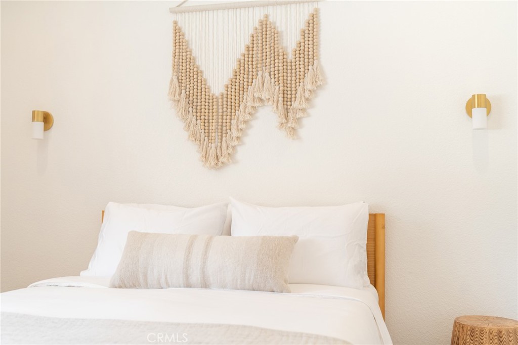 57508 Buena Suerte Road Yucca Valley, CA 92284 - Photo 35 of 61 a bedroom with a bed and a large window