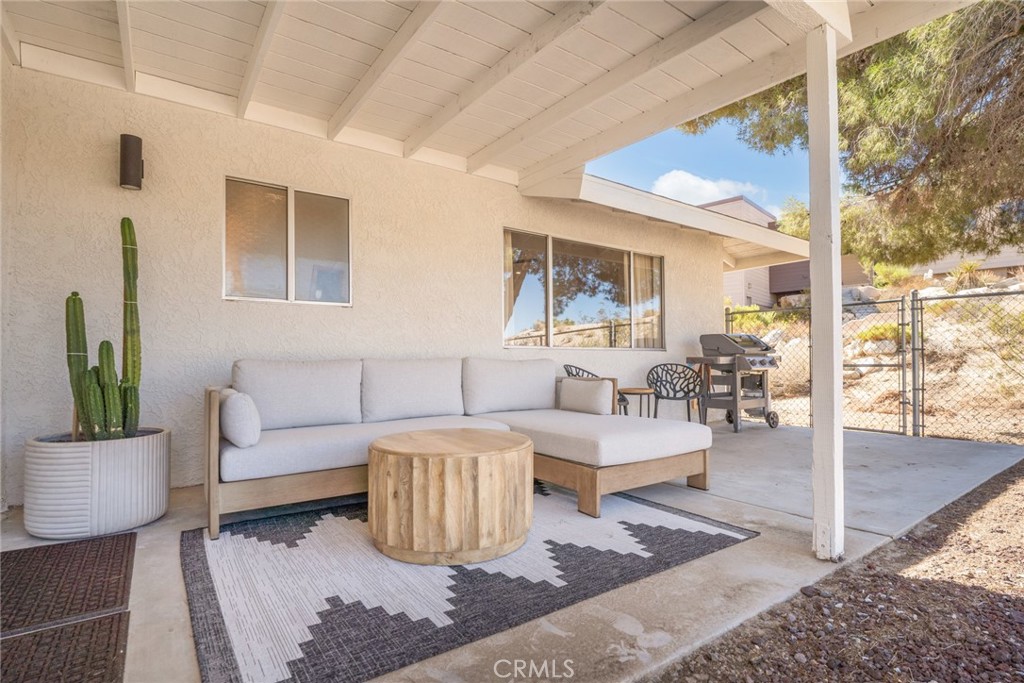 57508 Buena Suerte Road Yucca Valley, CA 92284 - Photo 52 of 61 a living room with furniture and a large window