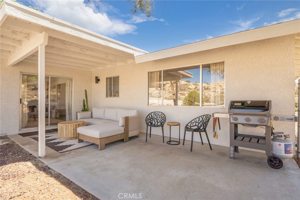 57508 Buena Suerte Road Yucca Valley, CA 92284 - Photo 55 of 61 a living room with furniture and a window