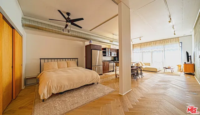 a bedroom with a bed a table and chair