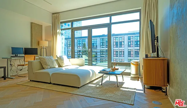 a bedroom with a bed and large windows