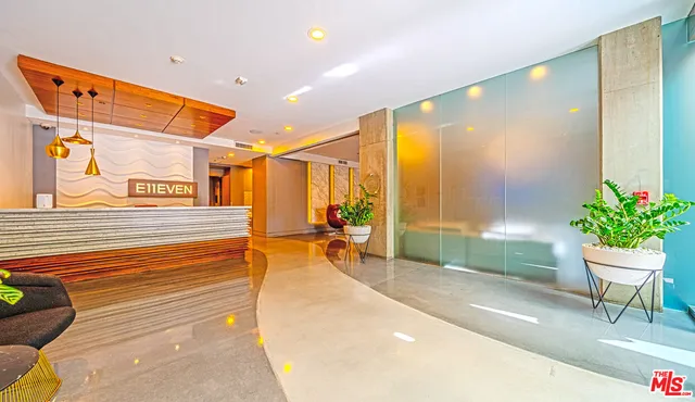 a balcony with chairs and a potted plant