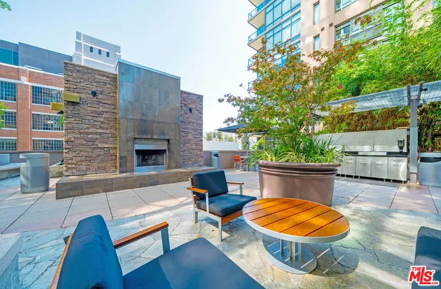 a outdoor space with a fireplace and a potted plant