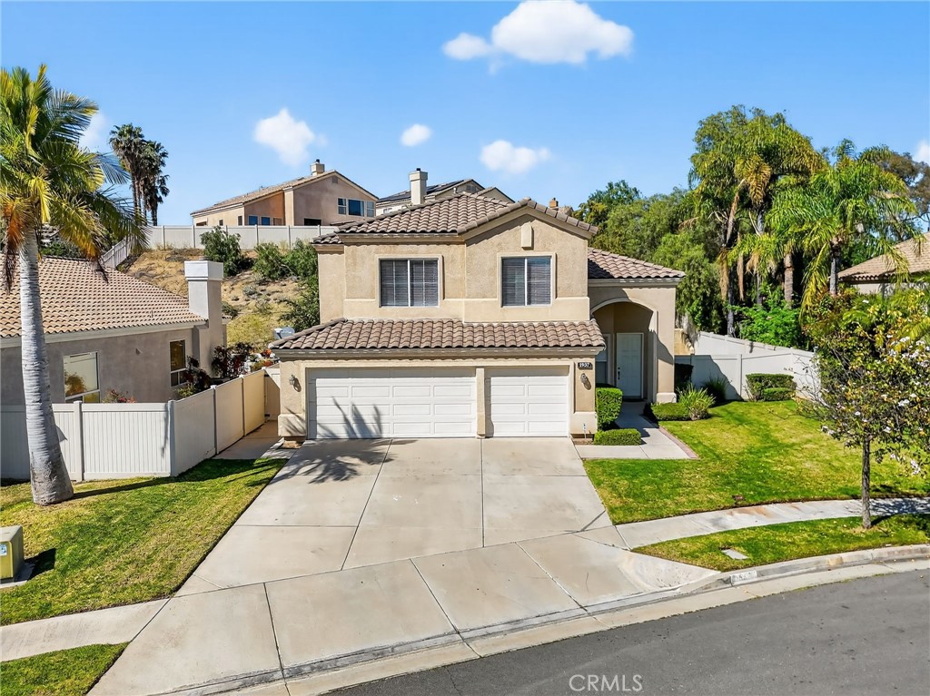 1937 Madera Circle Corona, CA 92879 - Photo 1 of 1 a front view of a house with a yard and potted plants