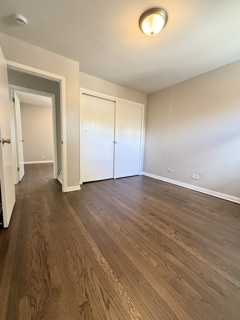 1820 169th Street Hazel Crest, IL 60429 - Photo 15 of 23 an empty room with wooden floor and windows