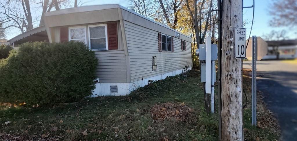 a view of a house with a yard and tree s
