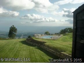 11 B White Oak Mountain Road Columbus, NC 28722 - Photo 6 of 8 a view of a water pond with lots of buildings in the background