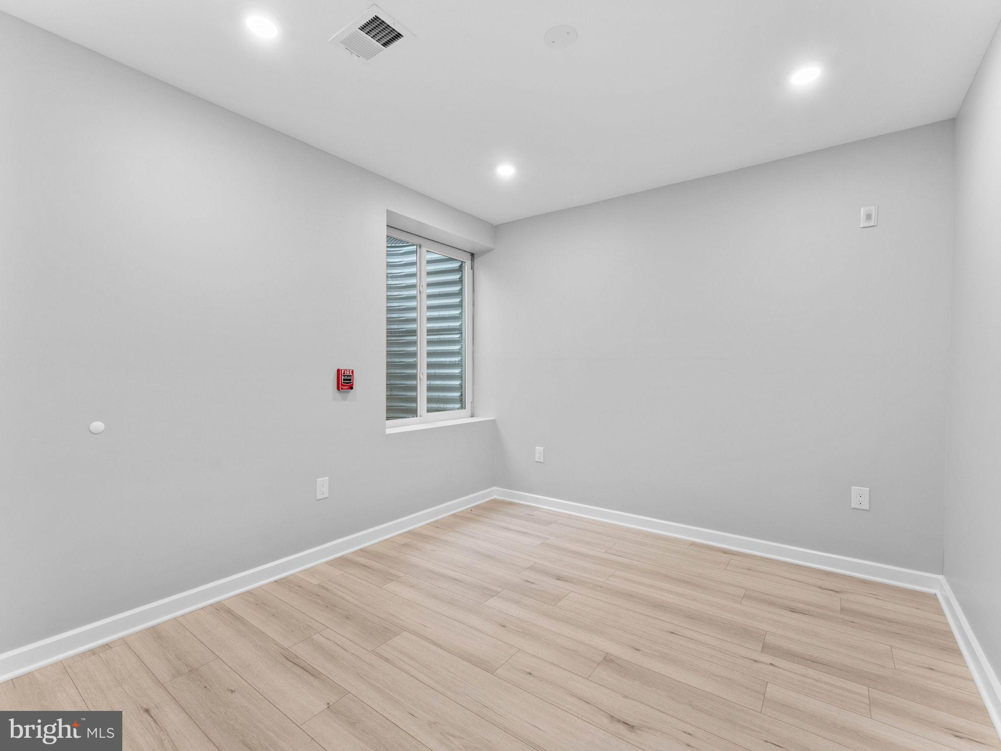 1682 North 54th Street, Unit 2 Philadelphia, PA 19131 - Photo 11 of 15 wooden floor in an empty room with a window