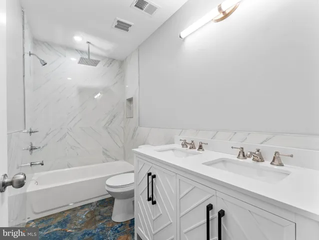 a bathroom with a sink a toilet and a bathtub