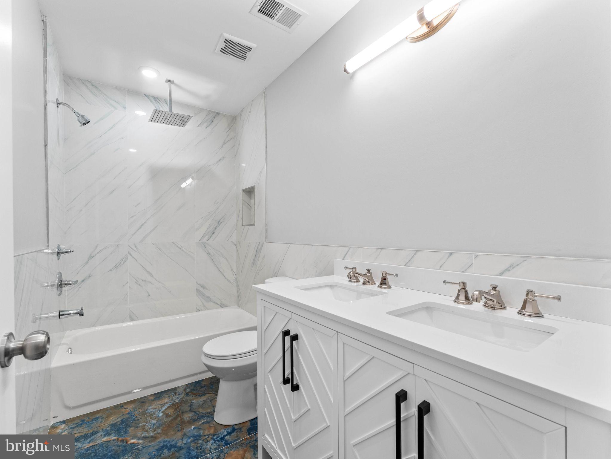 1682 North 54th Street, Unit 2 Philadelphia, PA 19131 - Photo 13 of 15 a bathroom with a sink a toilet and a bathtub