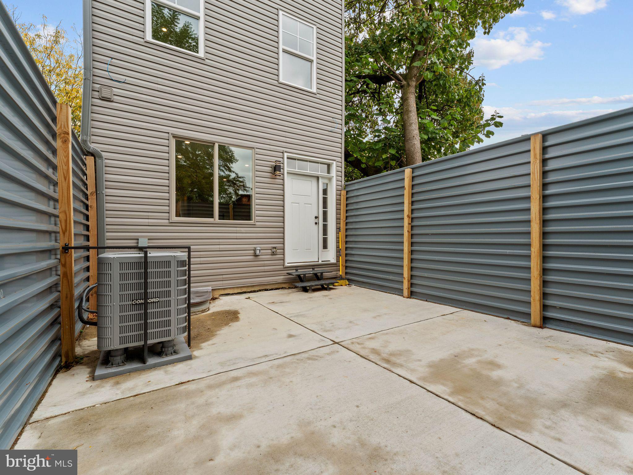1682 North 54th Street, Unit 2 Philadelphia, PA 19131 - Photo 15 of 15 a view of a house with a yard and garage