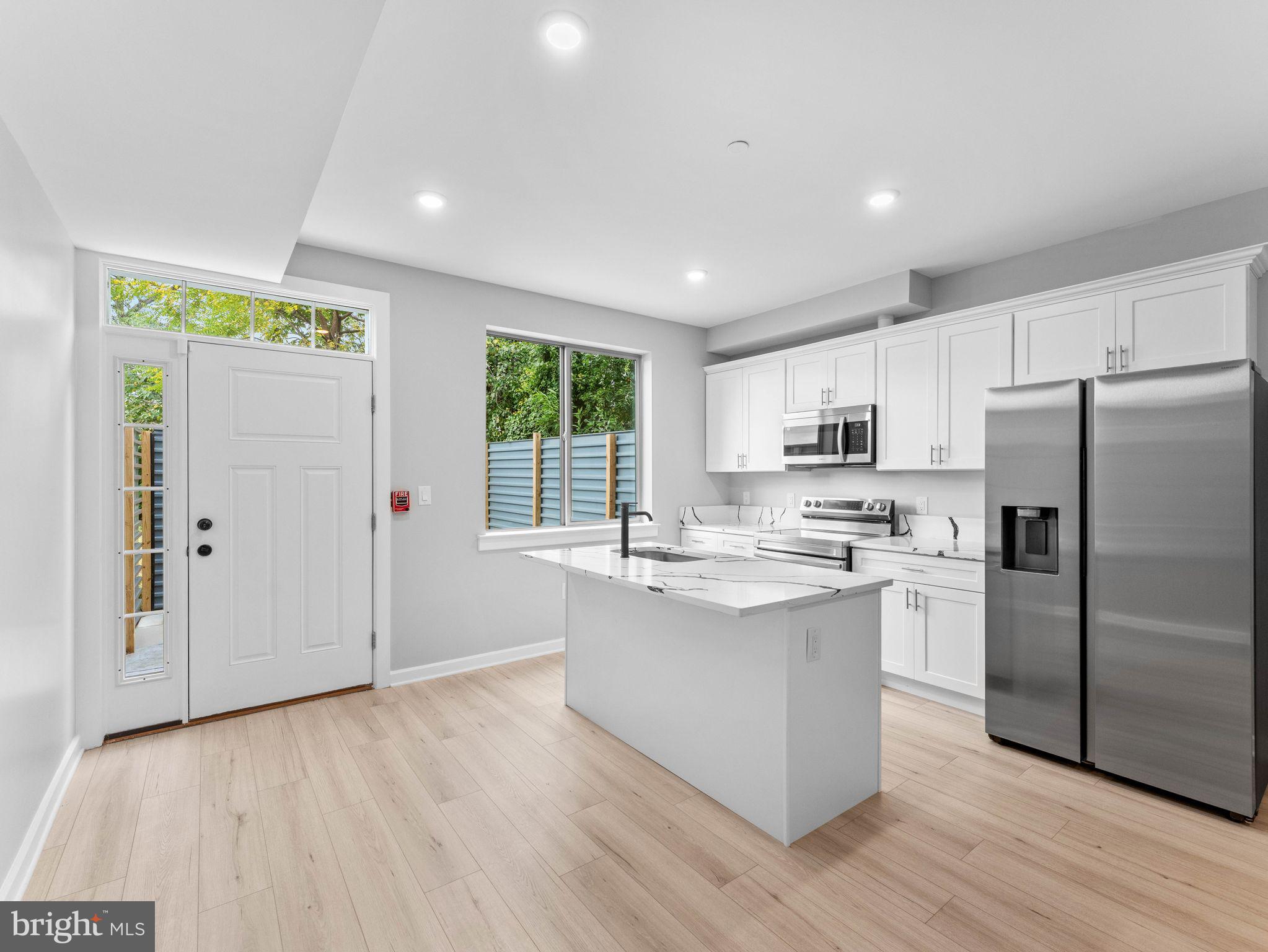 1682 North 54th Street, Unit 2 Philadelphia, PA 19131 - Photo 7 of 15 a kitchen with stainless steel appliances granite countertop a refrigerator and a stove top oven