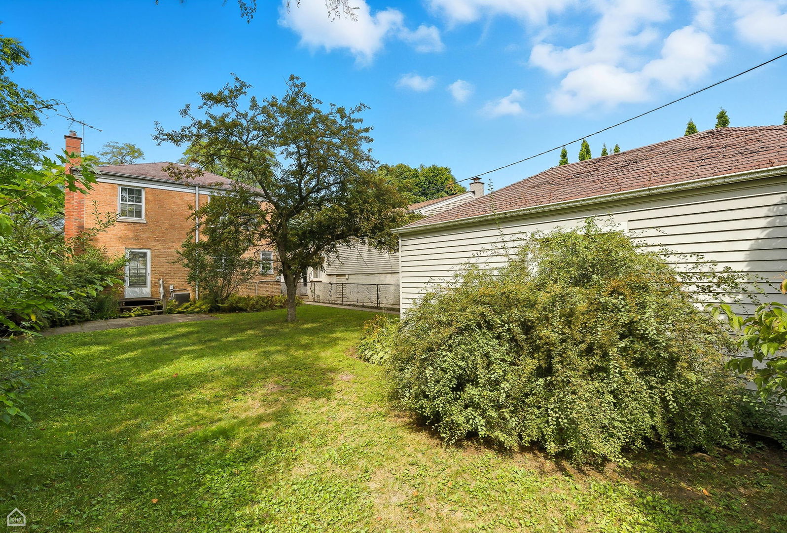 8301 Karlov Avenue Skokie, IL 60076 - Photo 17 of 21 a yellow house with tree in front of it