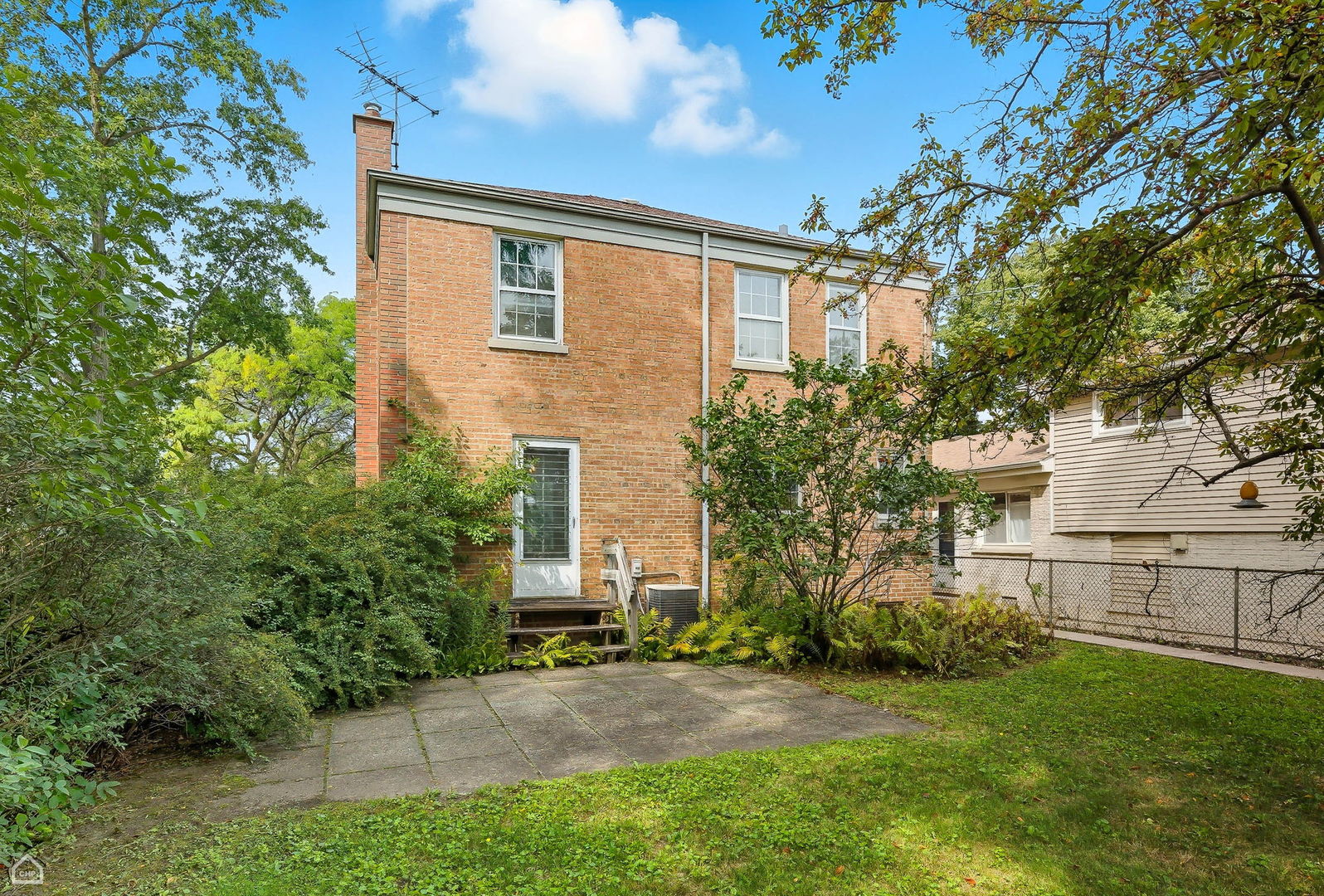8301 Karlov Avenue Skokie, IL 60076 - Photo 18 of 21 a view of a house with a yard and sitting area
