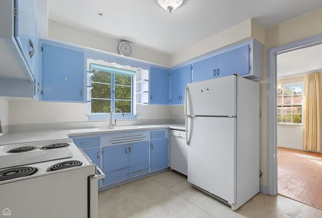 a kitchen with a stove a refrigerator and a sink