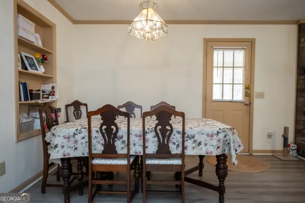 a view of a dining room with furniture and chandelier