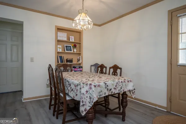 a view of a dining room with furniture and wooden floor