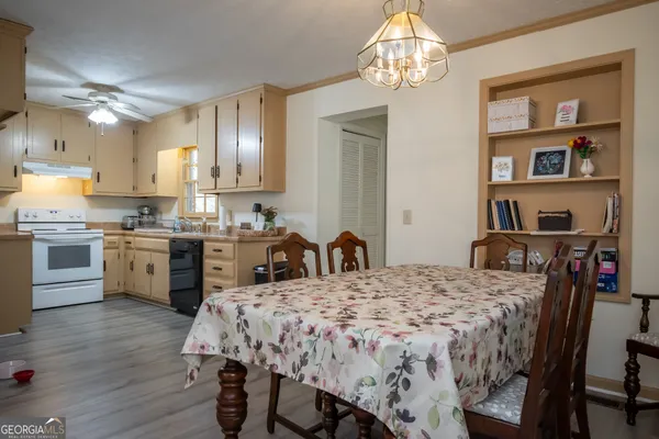 a kitchen with a table chairs refrigerator and cabinets