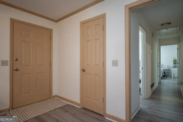 a view of a hallway with wooden floor