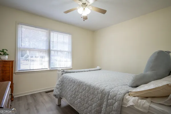 a bedroom with a bed and a window