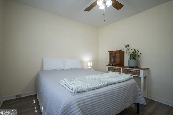 a bedroom with a bed and a ceiling fan