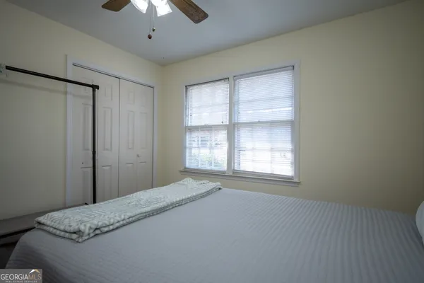 a bedroom with a bed and a window