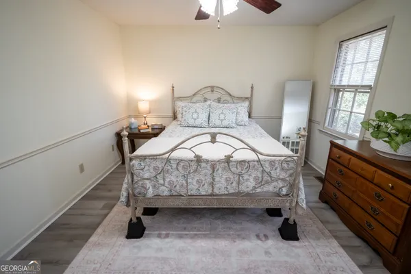 a bed sitting in a bedroom next to a window