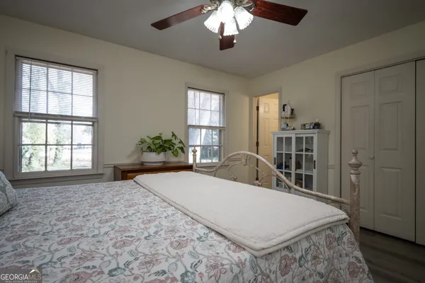 a large bedroom with a large bed and a chandelier