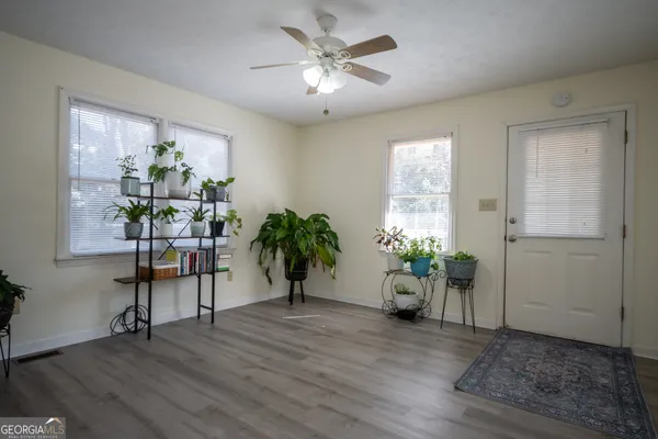 a living room with furniture and a potted plant
