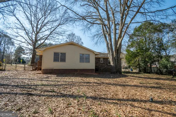 a house covered with trees in the background