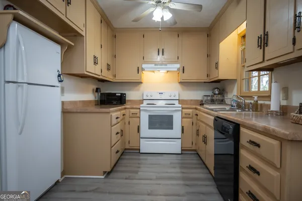 a kitchen with white cabinets stainless steel appliances and sink