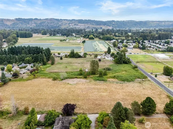 an aerial view of residential houses with outdoor space and river