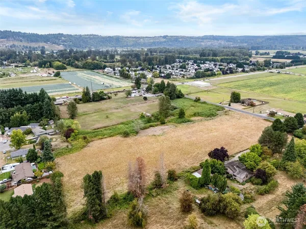 an aerial view of residential houses with outdoor space and river