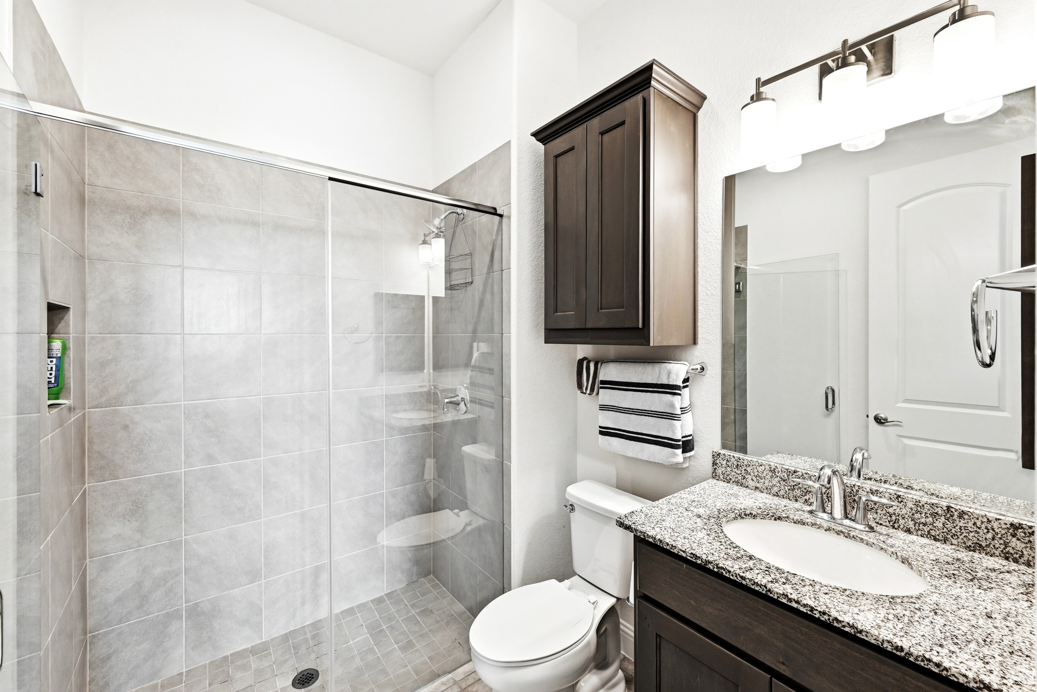 4601 Apollonia Way Leander, TX 78641 - Photo 23 of 40 a bathroom with a granite countertop sink toilet mirror and shower