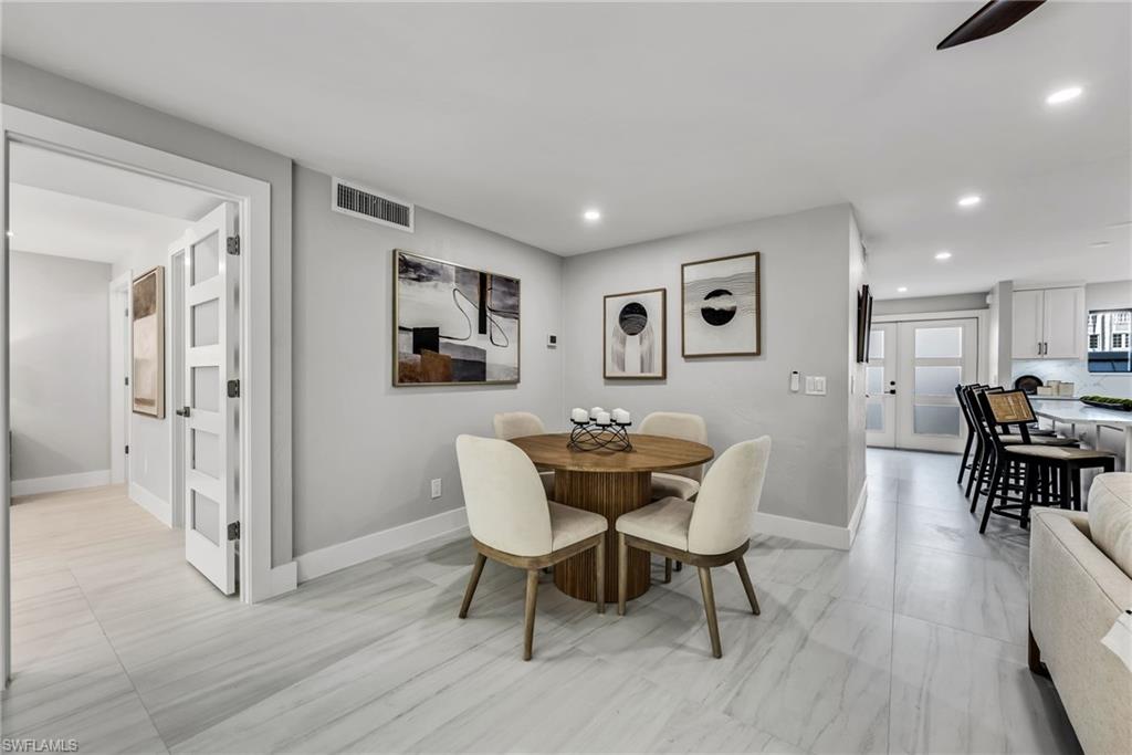 990 8th Street South, Unit 1C Naples, FL 34102 - Photo 11 of 24 a view of a dining room with furniture and wooden floor