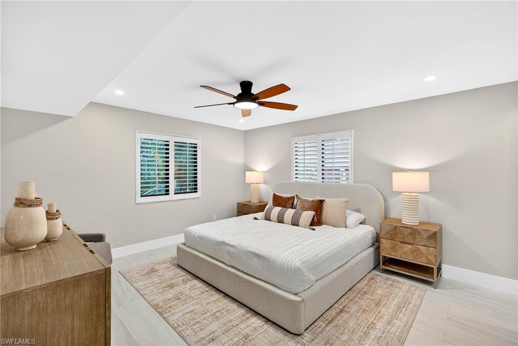990 8th Street South, Unit 1C Naples, FL 34102 - Photo 12 of 24 a bedroom with a bed and a window