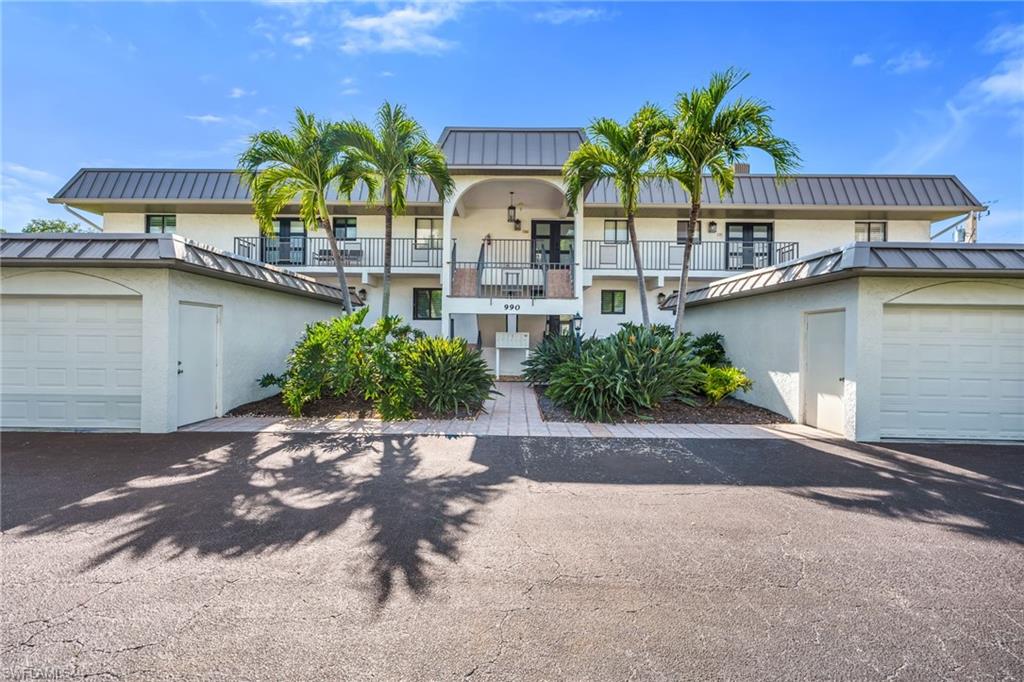 990 8th Street South, Unit 1C Naples, FL 34102 - Photo 21 of 24 a front view of house with yard and green space