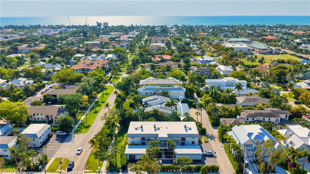 990 8th Street South, Unit 1C Naples, FL 34102 - Photo 22 of 24 an aerial view of residential houses with outdoor space