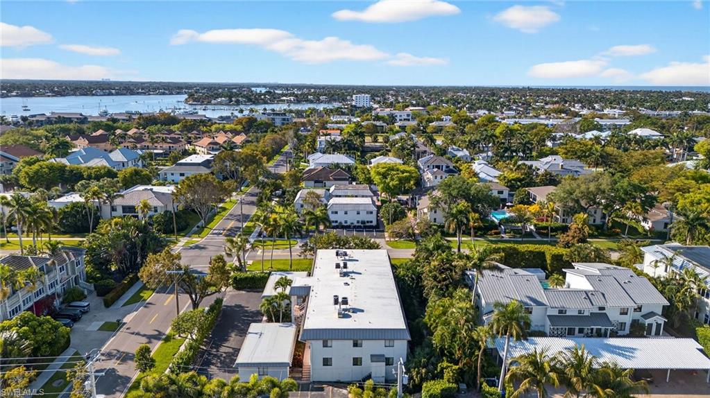 990 8th Street South, Unit 1C Naples, FL 34102 - Photo 23 of 24 an aerial view of a residential apartment building with a yard