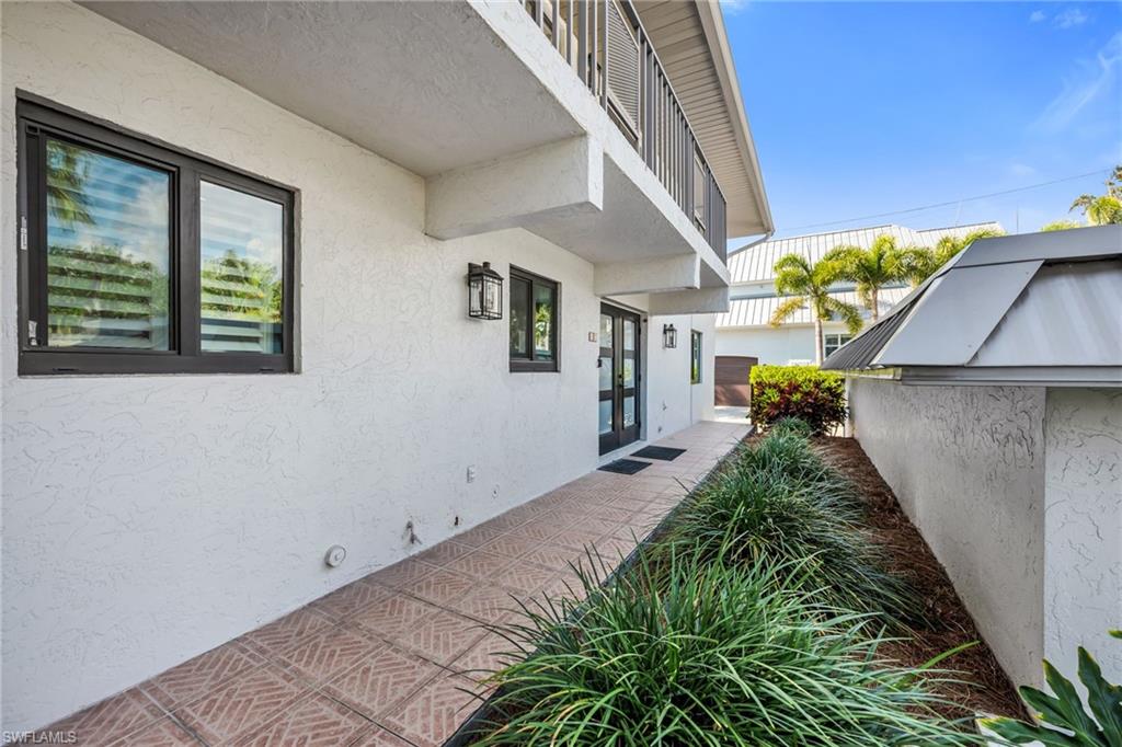 990 8th Street South, Unit 1C Naples, FL 34102 - Photo 24 of 24 a very nice looking house with potted plants in front of it