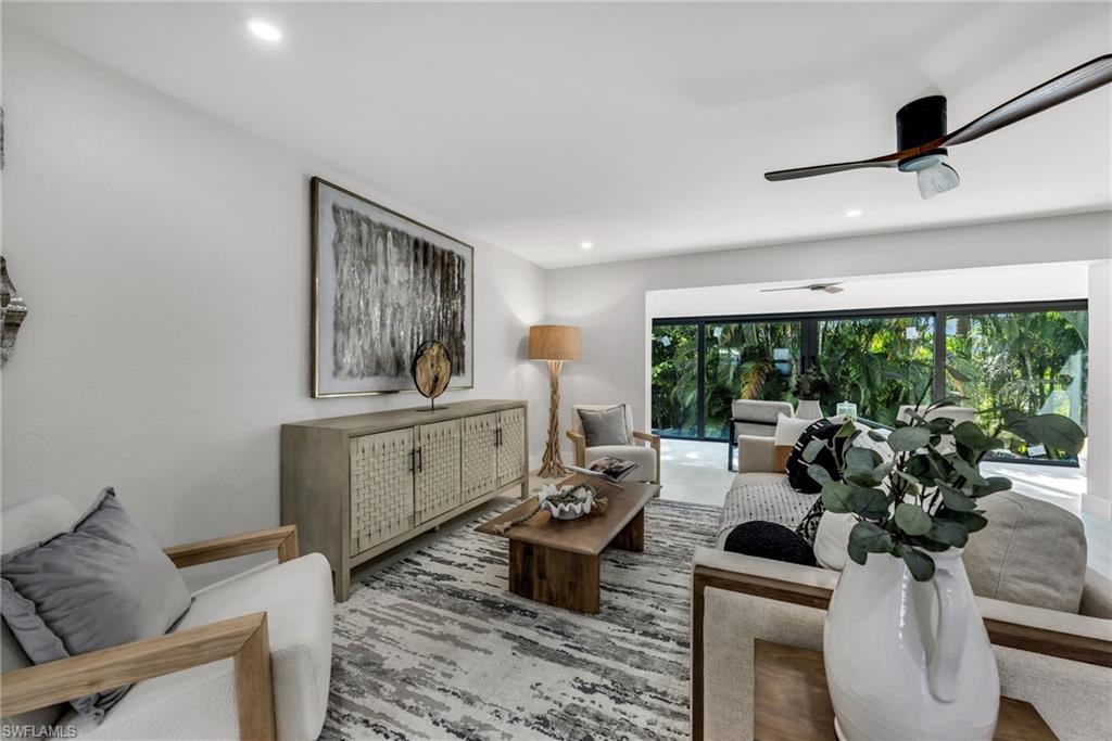 990 8th Street South, Unit 1C Naples, FL 34102 - Photo 6 of 24 a living room with furniture and a large window