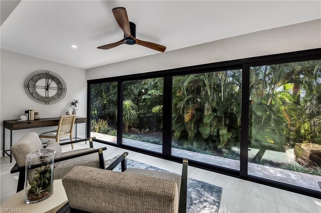 990 8th Street South, Unit 1C Naples, FL 34102 - Photo 8 of 24 a living room with hardwood floor and a large window