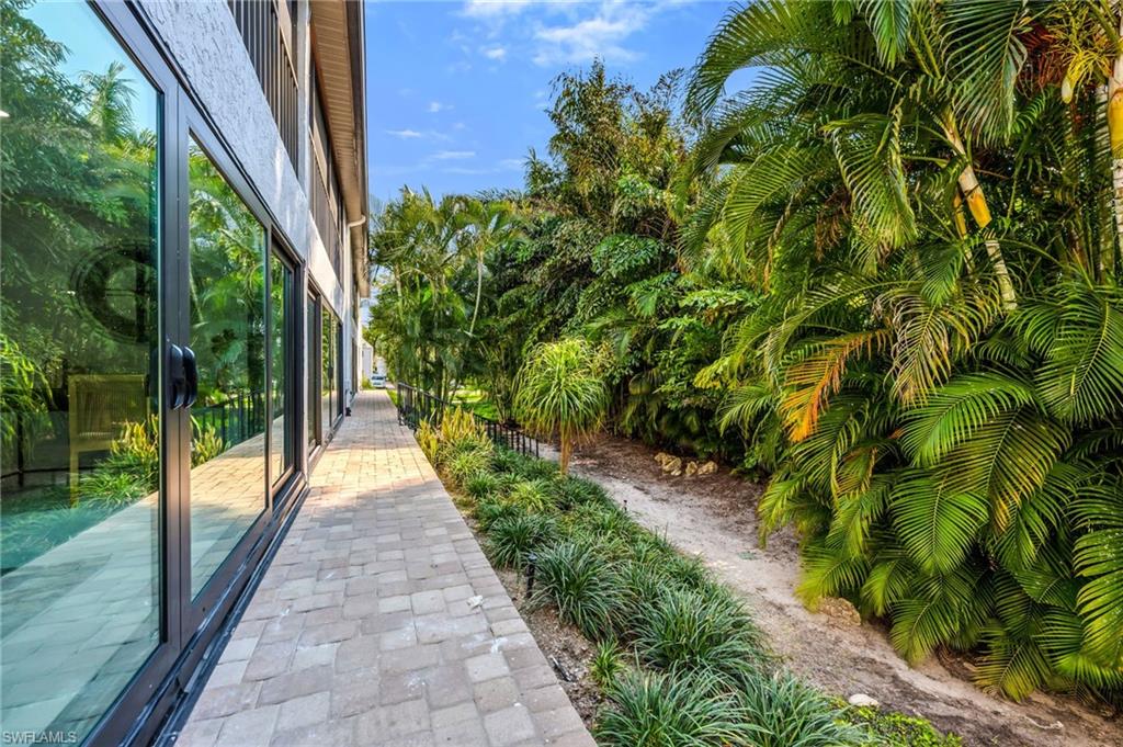 990 8th Street South, Unit 1C Naples, FL 34102 - Photo 9 of 24 a view of a garden with pathway