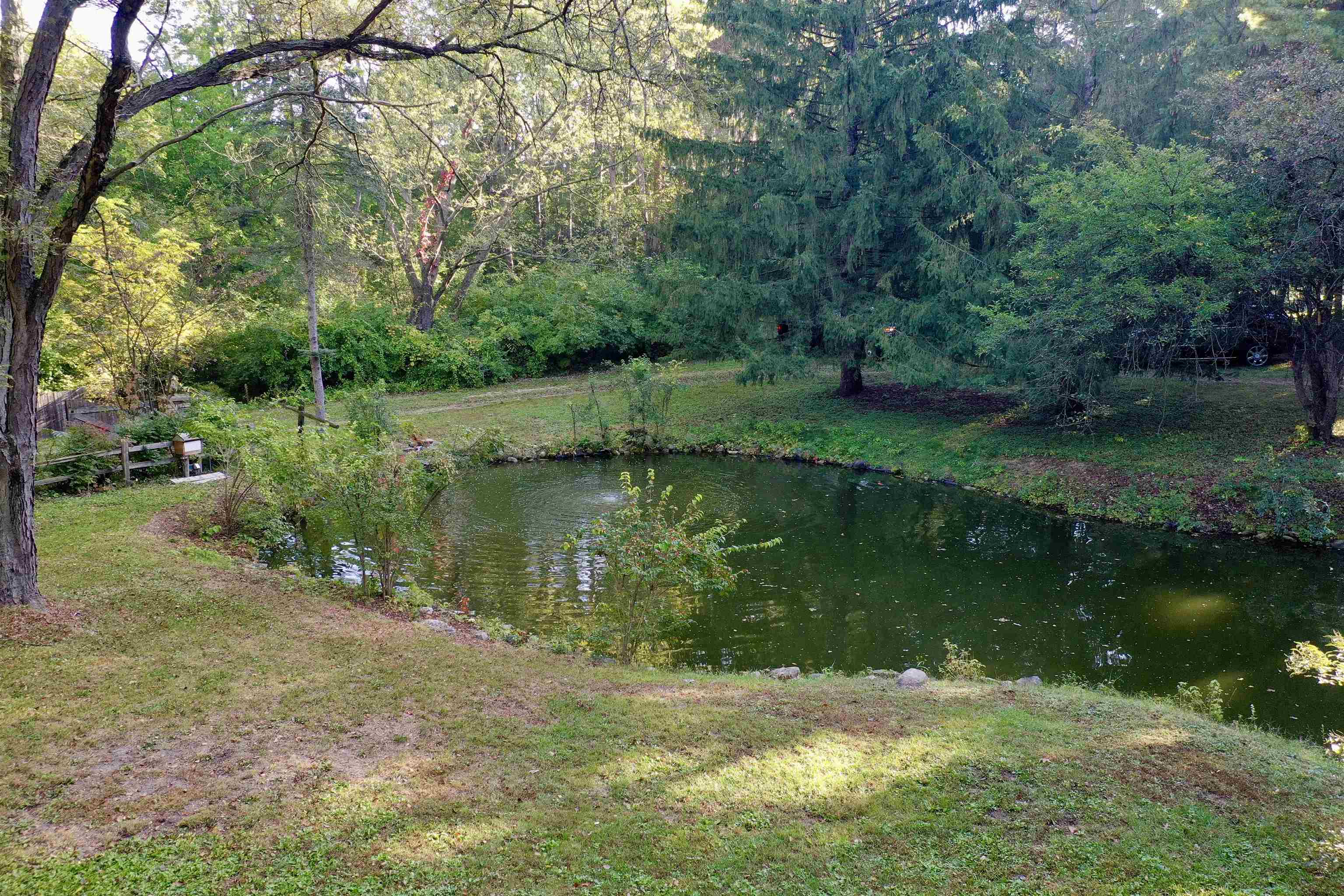 7145 South Rock Nation Road Dixon, IL 61021 - Photo 48 of 72 a view of a lake with a yard and large trees
